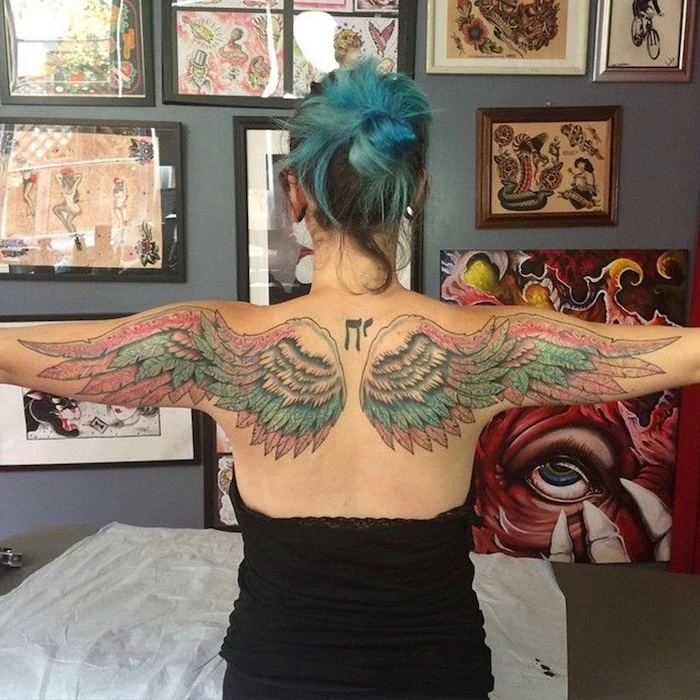 woman with blue hair, back tattoo, wings neck tattoo, blue and pink colors, black top