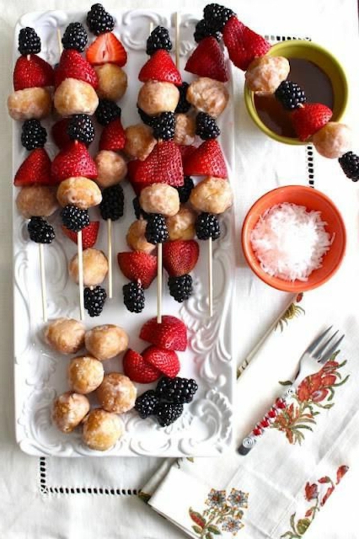small bites, strawberries and blackberries, on wooden skewers, breakfast finger foods, white plate