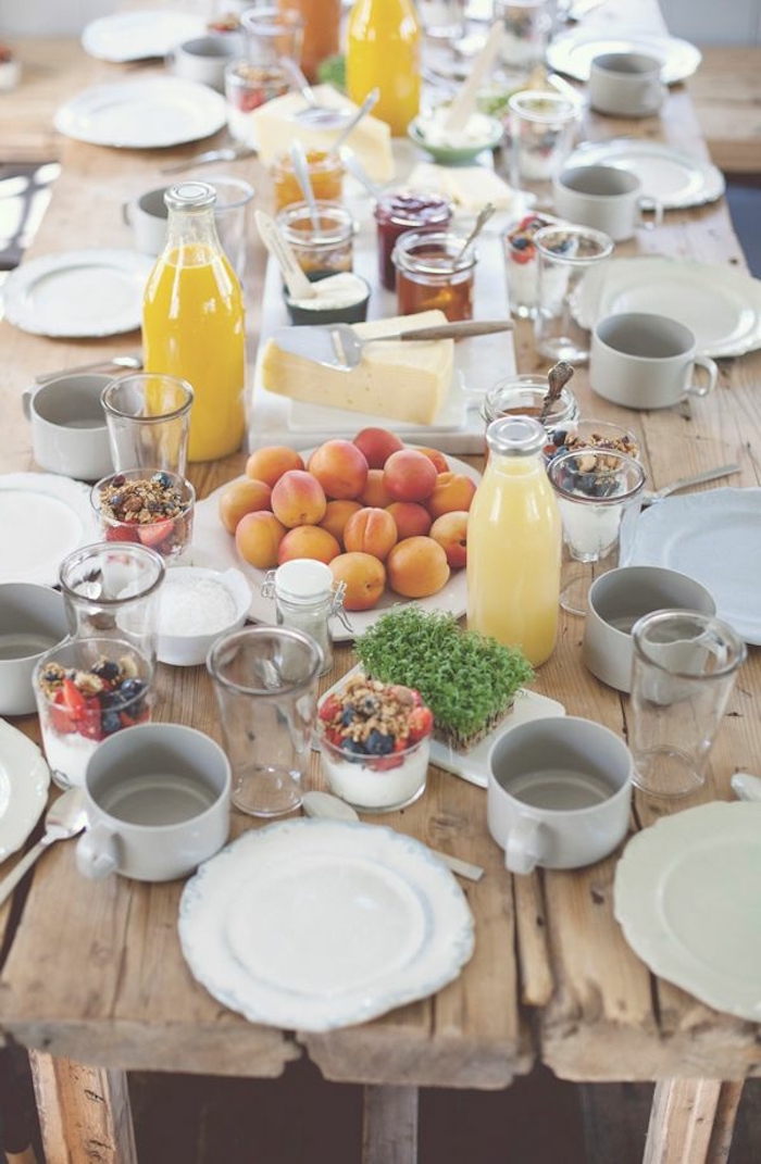 brunch table, orange juice, breakfast recipe ideas, fruit plate, yoghurt and granola in glasses, wooden table