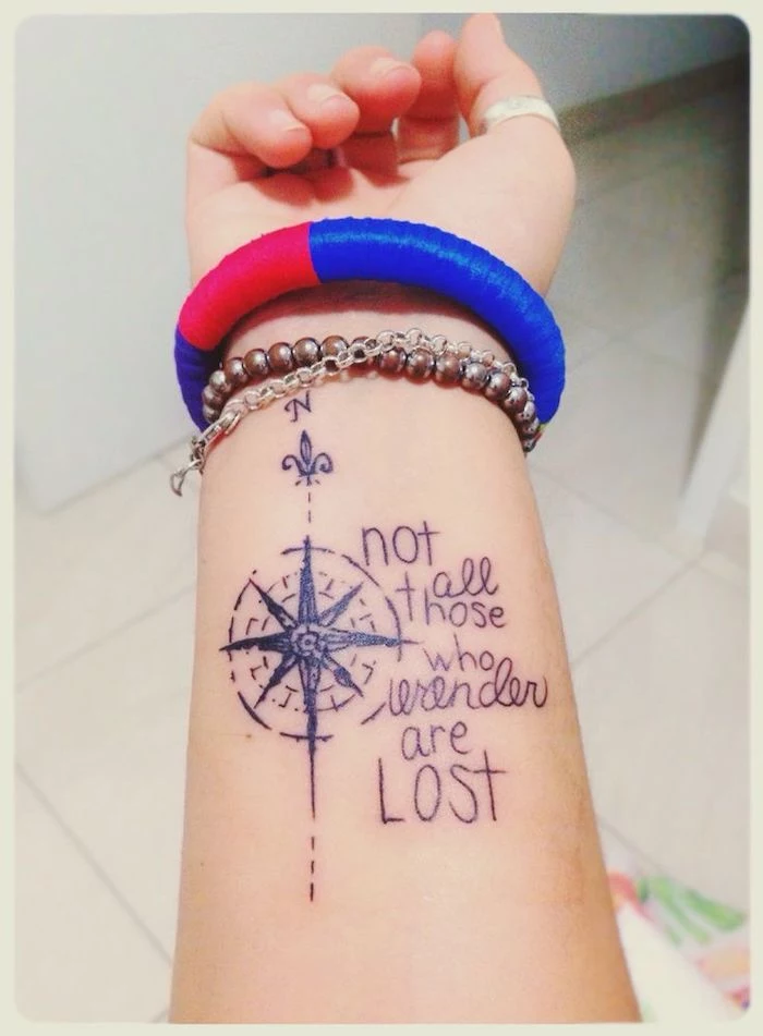 not all those who wander are lost, wrist tattoo, compass tattoo design, silver bracelets, white background
