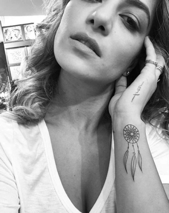 black and white photo, wrist tattoo, woman with white t shirt, dream catcher tattoo ideas