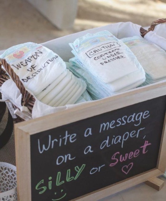 write a message on a diaper, silly or sweet, diy baby shower decorations, basket full of diapers, fun game