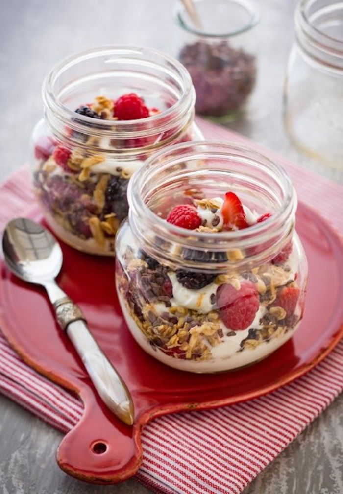 granola and yoghurt, raspberries and strawberries, inside a jar, breakfast recipe ideas, red tray
