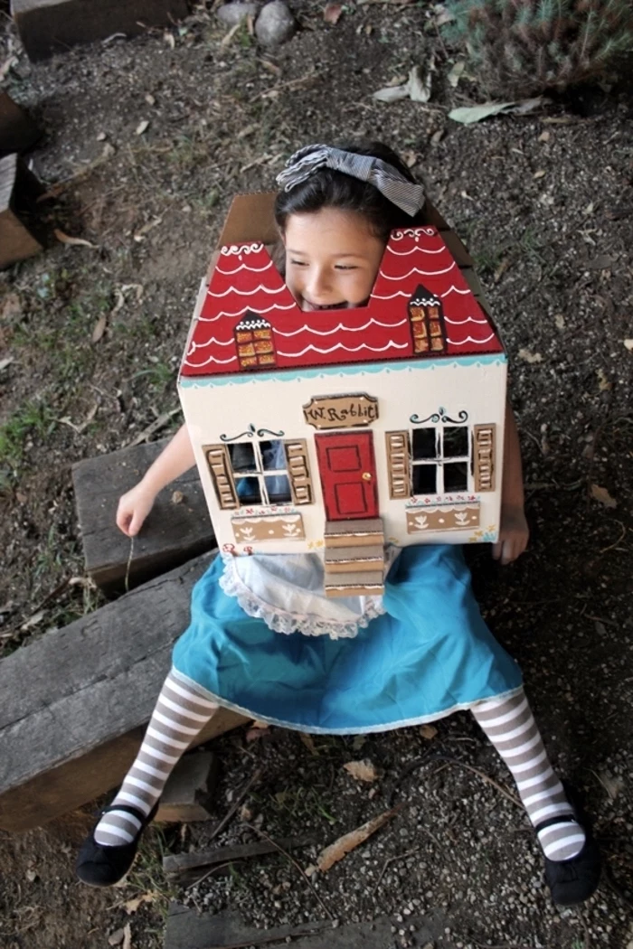 girl dressed as alice in wonderland, growing big, inside the house, halloween costume ideas, sitting on a wooden bench