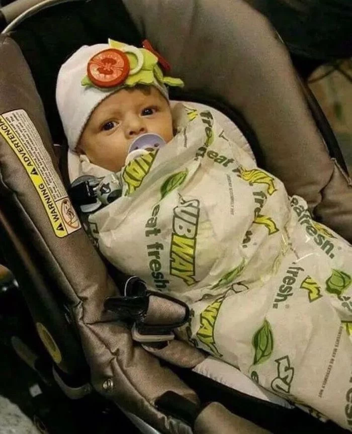baby in a stroller, wrapped as a subway sandwich, white beanie, with vegetables, halloween costumes for kids girl