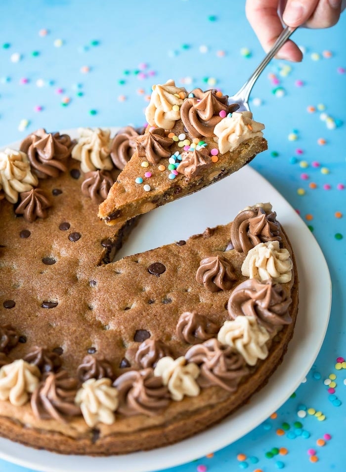 cookie dough cake, how to make chocolate chip cookies, sprinkles on top, white plate, blue table