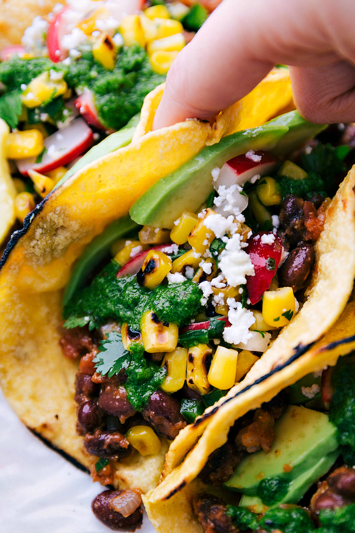 tortilla wraps, filled with beef, corn and turnip, avocado slices, ground beef tacos