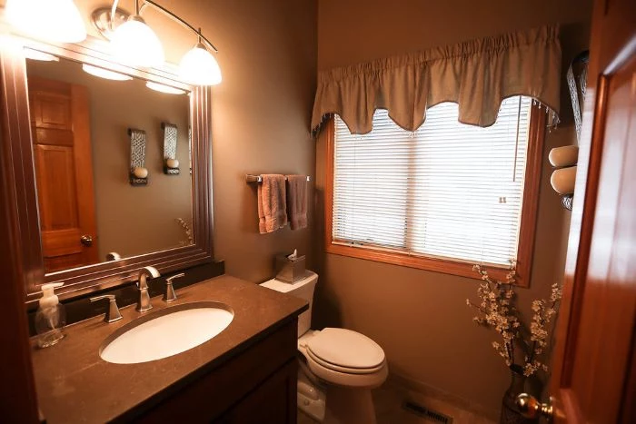tips for your bathroom remodel, beige walls, square mirror, wooden vanity, small mirror, with blinds