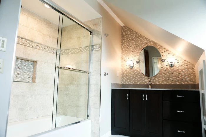 beige walls, mosaic accent wall, tips for your bathroom remodel, black vanity, shower cabin