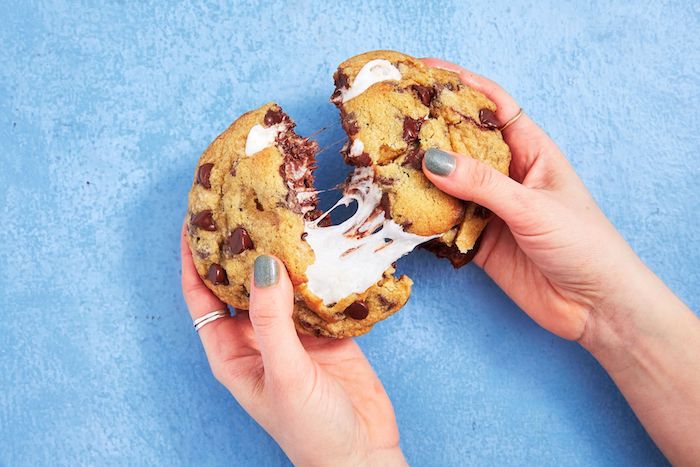 large cookie, marshmallow inside, split in half, how to make chocolate chip cookies, blue table