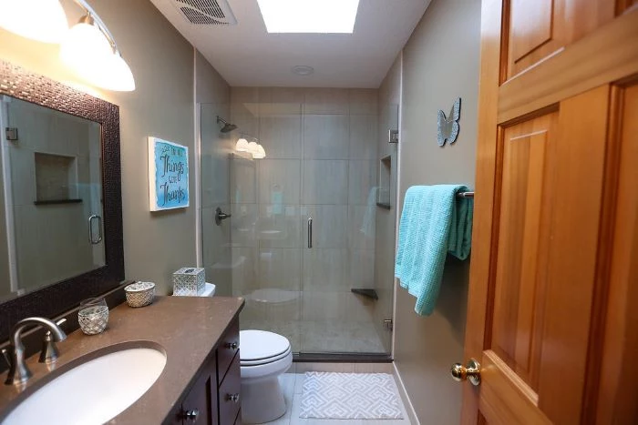 shower cabin, beige walls, square mirror, wooden vanity, tips for your bathroom remodel, blue towel