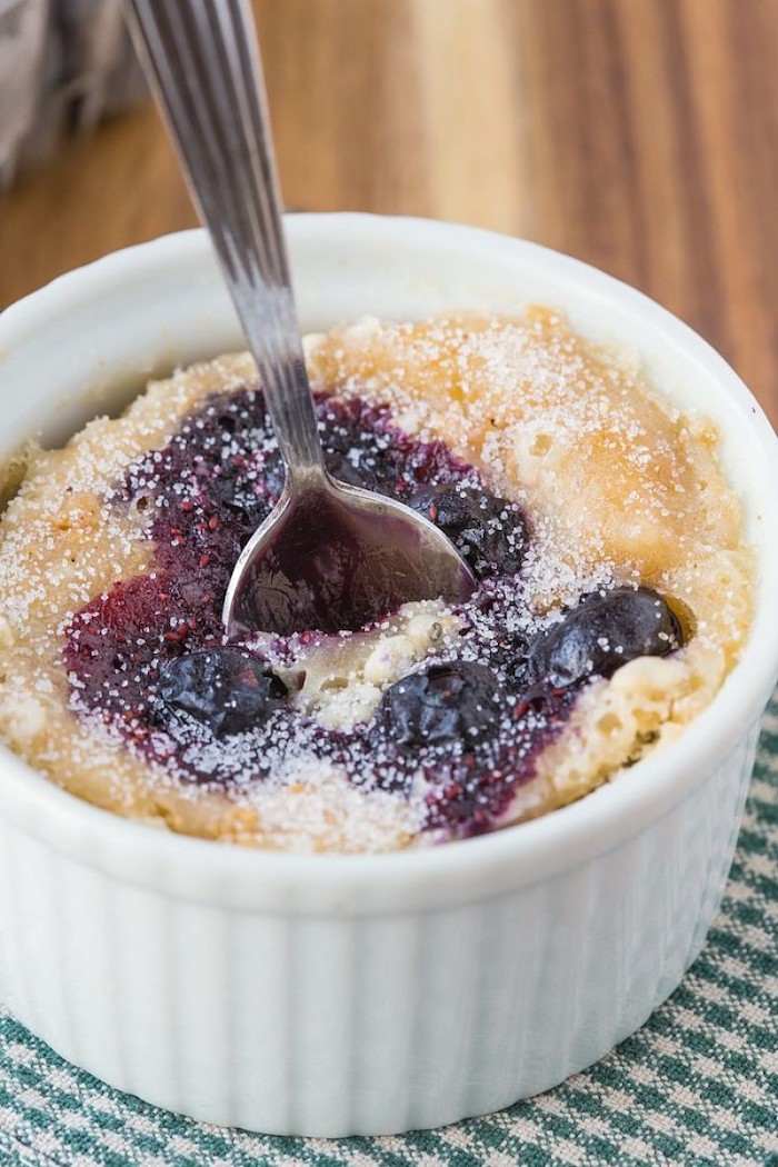 blueberry muffin, in a white cup, with silver spoon, keto diet recipes, green and white cloth, wooden table