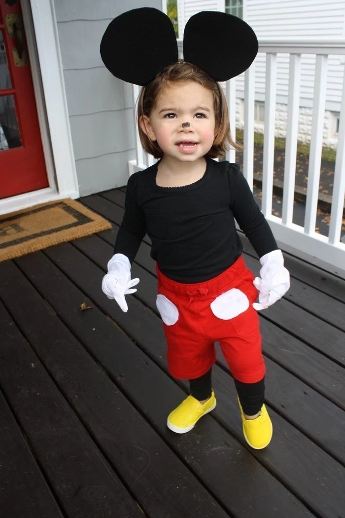 little boy, dressed as mickey mouse, yellow shoes, toddler halloween costumes, red pants, black mouse ears