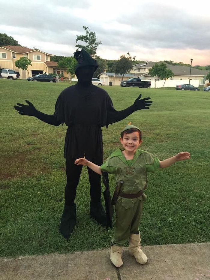 boy dressed as peter pan, man dressed as his shadow, toddler boy costume, standing on a grass field