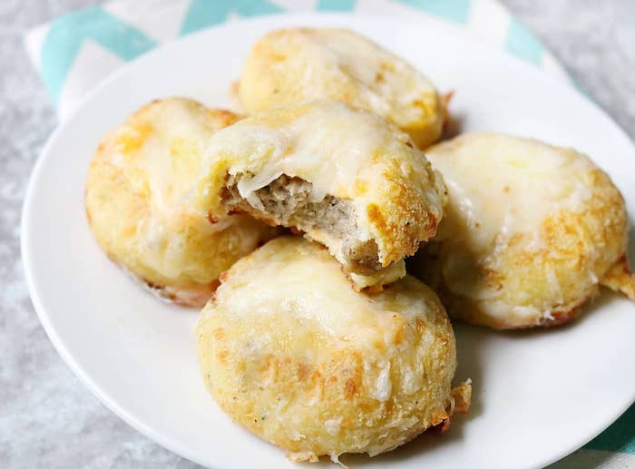 biscuits filled with minced meat, on white plate, cheese on top, easy keto breakfast, granite countertop