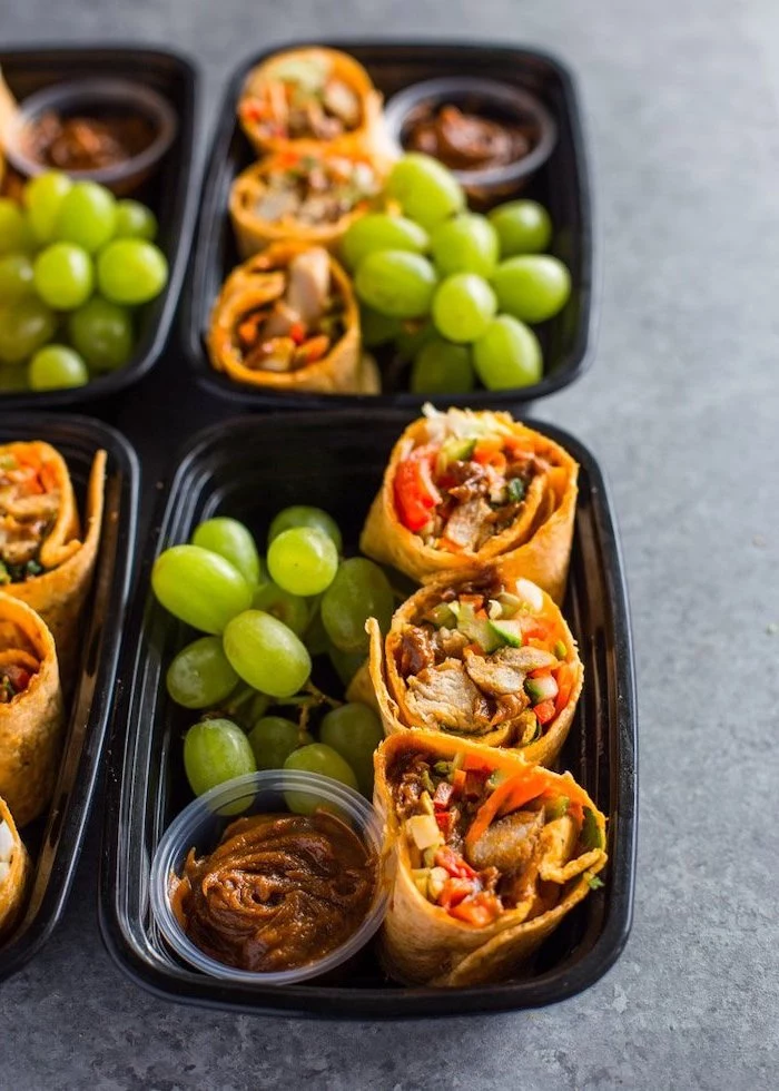 mini burritos, grapes and barbecue sauce, inside a black plastic container, easy meal prep ideas