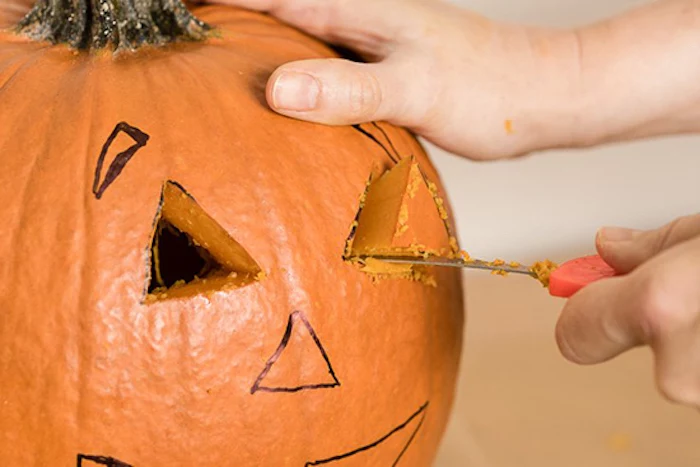 step by step, diy tutorial, scary pumpkin faces, cutting out shapes, into a pumpkin, with a knife