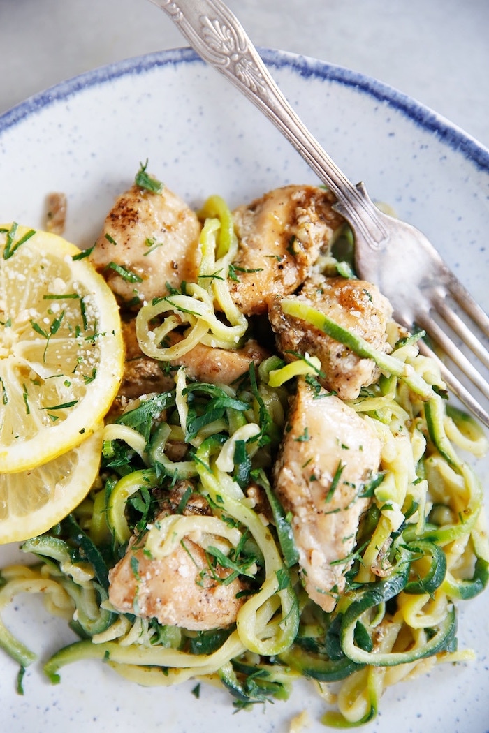 how to cook spiralized zucchini noodles, chicken fillet, zoodles with parsley, lemon slices, on the side
