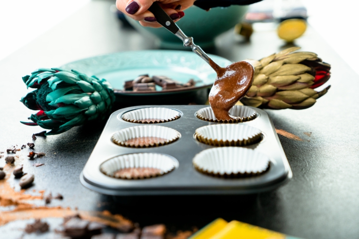 cucpcake mixture transfered to muffin baking sheet, chocolate cupcakes recipe, large spoon