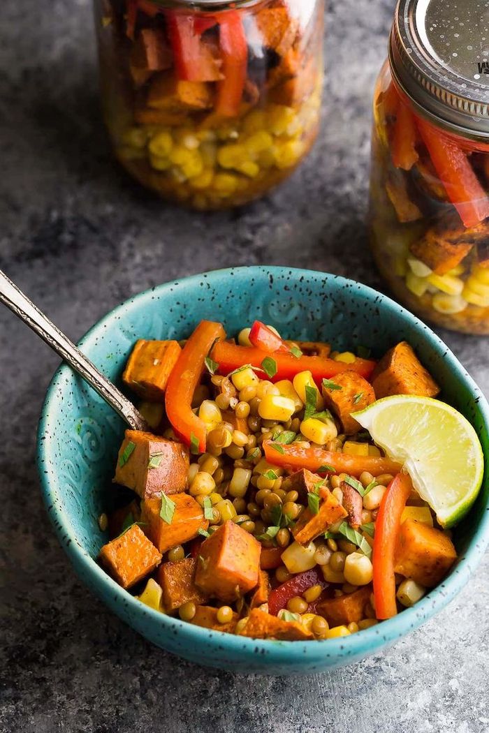 lentils and corn, sweet potato salad, inside a blue bowl, how to meal prep, lime slice on the side, granite countertop