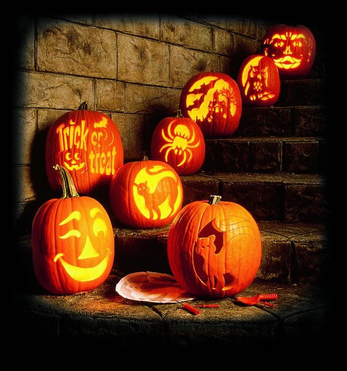 orange pumpkins, different things, carved in to them, pumpkin carving, arranged on steps, brick wall
