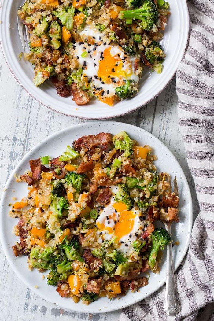 cauliflower rice, in white plates, best keto recipes, bacon and eggs, chives and peppers, wooden table