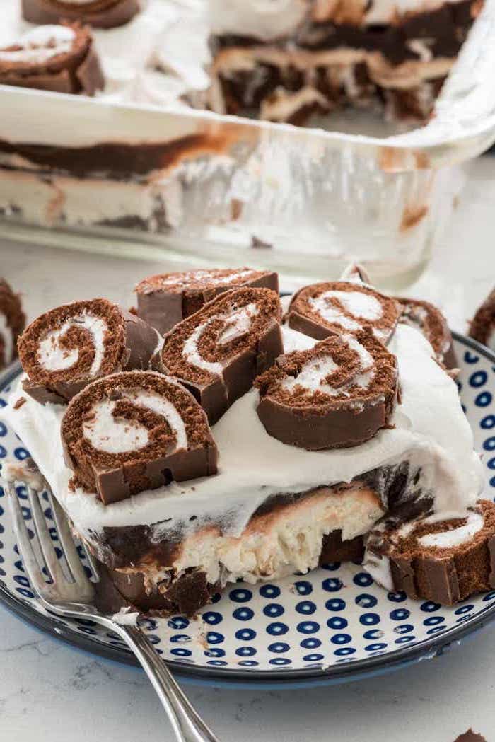 swiss roll cake, with chocolate and cream, easy summer desserts, blue and white plate, marble table