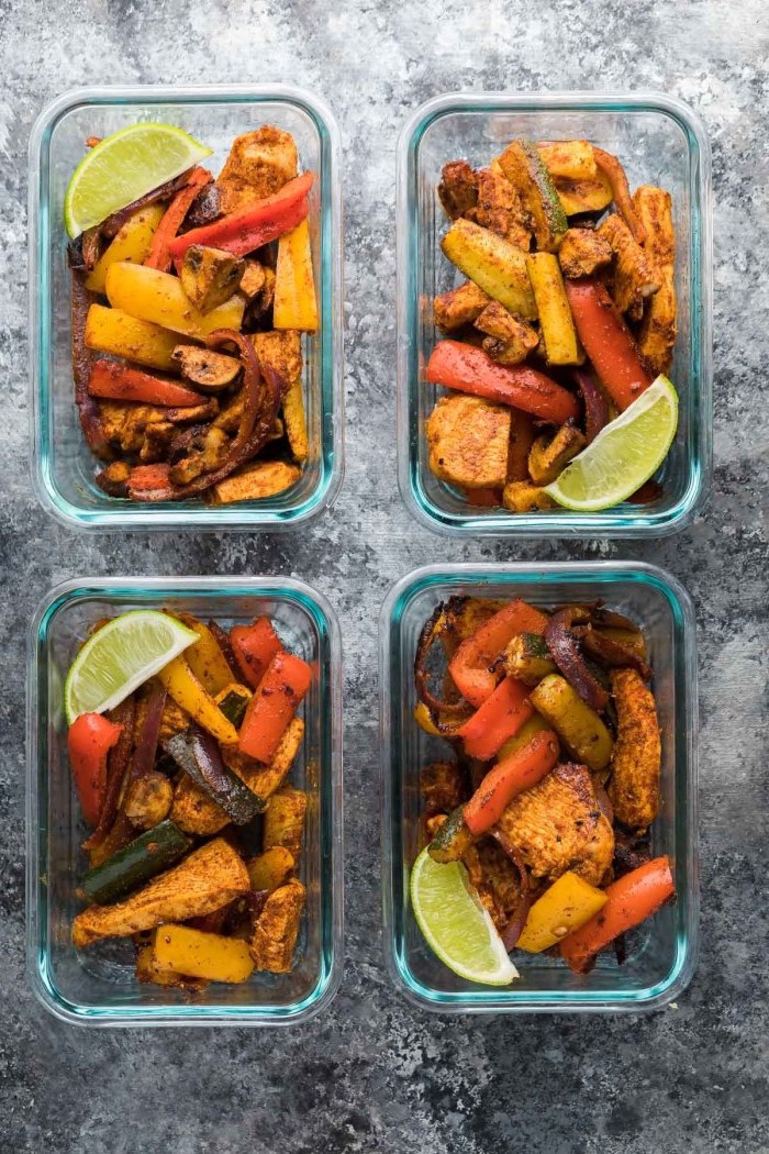 healthy meal prep, four glass containers, chicken fajitas, with zucchini and peppers, lime slice on the side