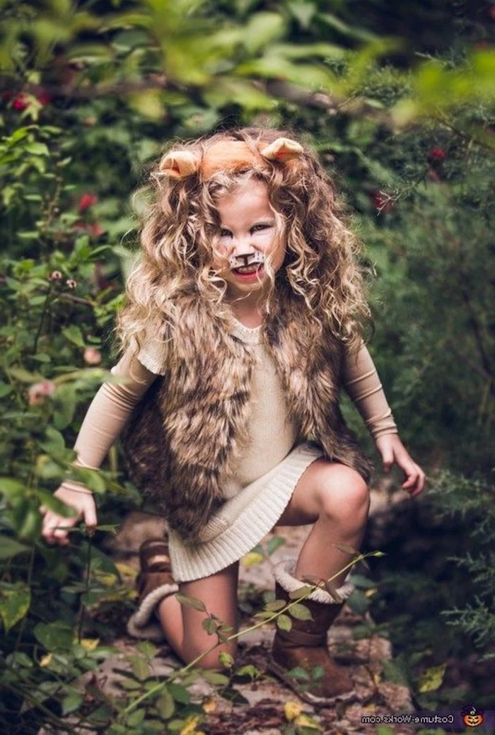girl dressed as a lion, baby girl halloween costumes, blonde curly hair, for a mane, furry vest