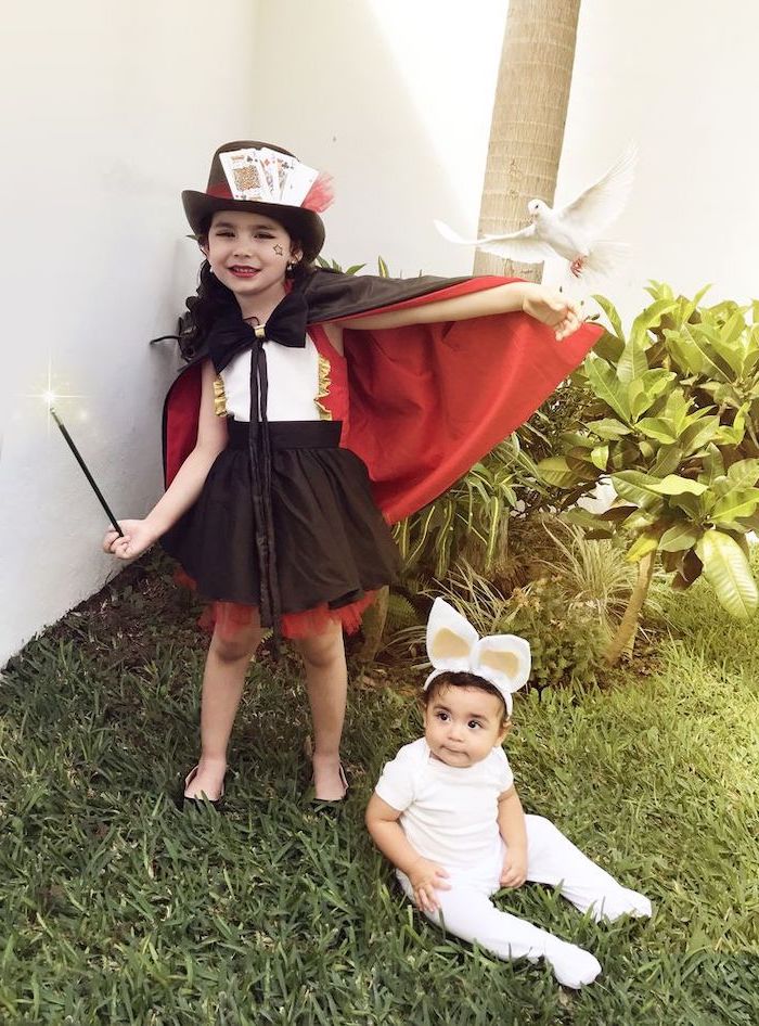 girl dressed as a magician, baby dressed as a rabbit, toddler girl costume, black and red cape, magic wand