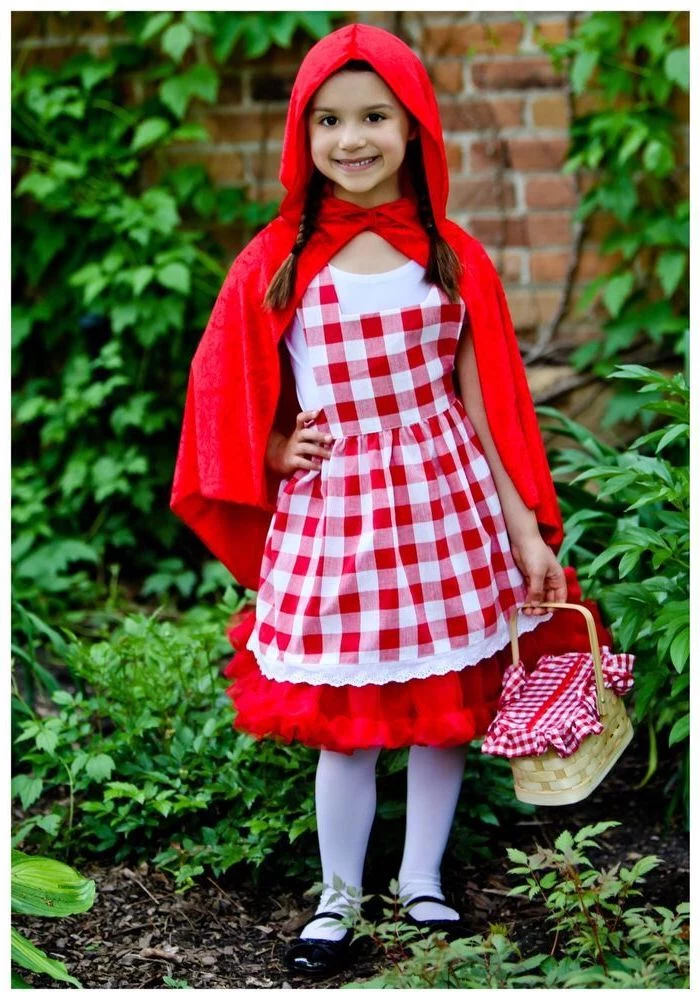 girl dressed as red riding hood, cool halloween costumes, red cape, lunch basket, braided hair