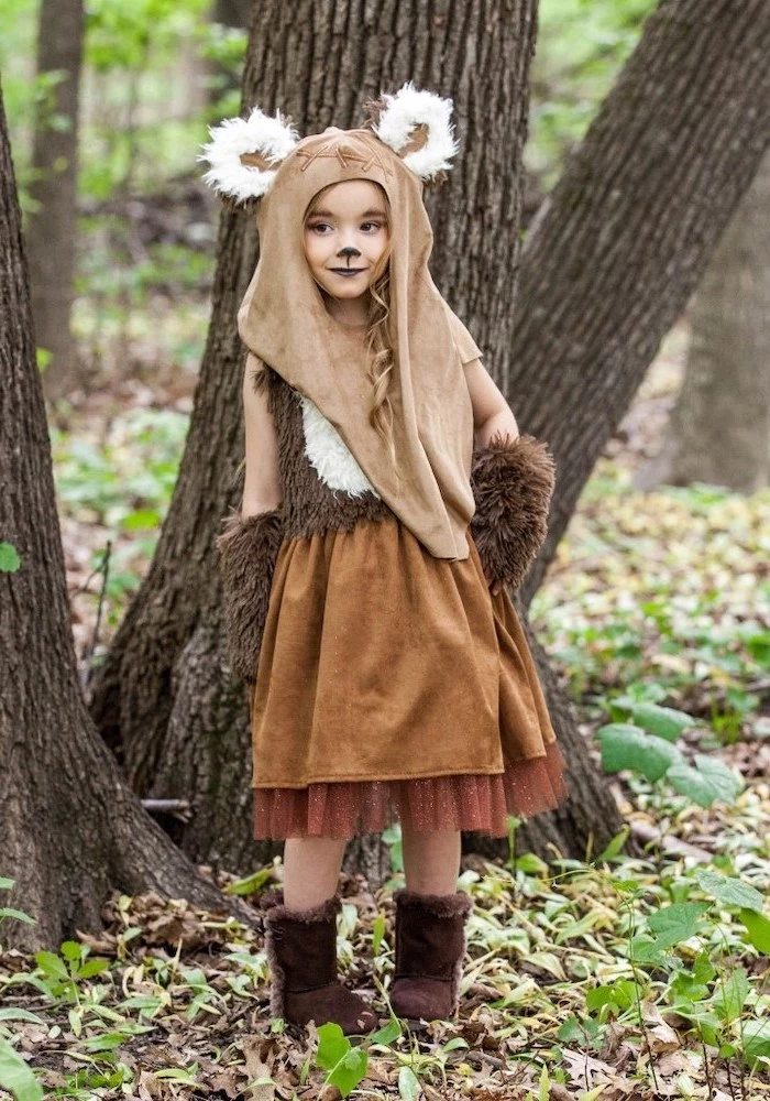girl dresses as wicket, star wars inspired, ewok character, cool halloween costumes, in the middle of the forrest
