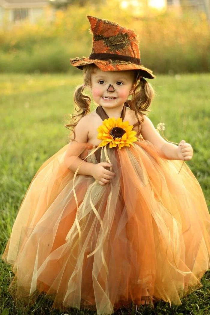 halloween costume ideas for girls, little girl, with blonde hair, in ponytails, dressed as a scarecrow, tulle skirt