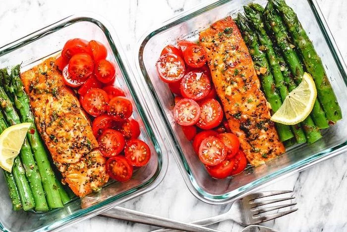 salmon and asparagus, cherry tomatoes, in a glass container, healthy meal prep ideas for weight loss, lemon slice