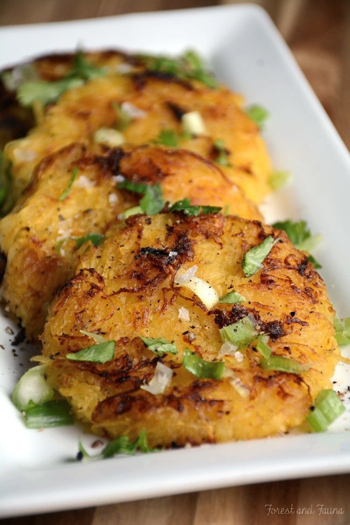 spaghetti squash, hash browns, low carb breakfast ideas, chives on top, white plate, wooden table