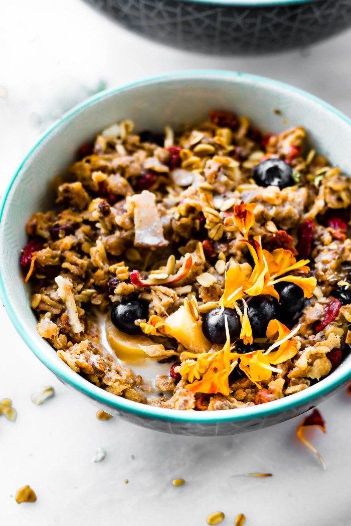 oatmeal and milk, blueberries and apples, inside a blue bowl, meal prep recipes, marble countertop