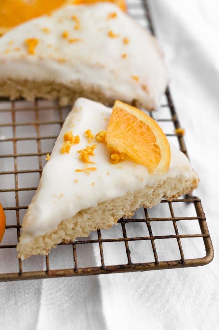 orange scones, keto breakfast recipes, orange slices, orange flakes on top, white frosting, metal rail