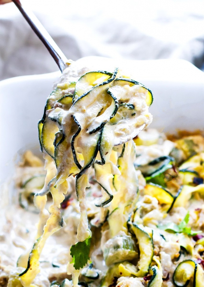 tuna zoodles, parsley on top, creamy sauce, in a white casserole, how to make zucchini noodles, silver spoon
