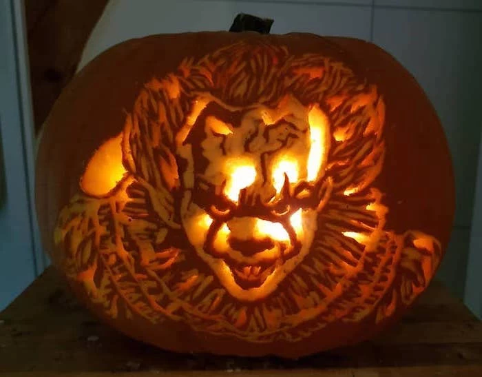 pennywise the dancing clown, it movie inspired, cute pumpkin carvings, lit by candles