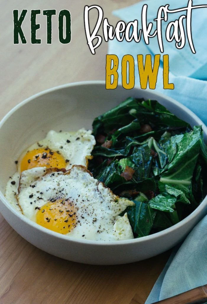 keto breakfast bowl, fried eggs, spinach with bacon, on the side, in a white bowl, wooden table, easy keto meals