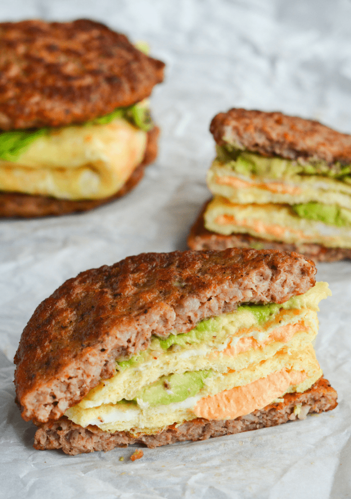 ground beef sandwich, ham and cheese omelet inside, guacamole sauce, keto diet breakfast, white paper