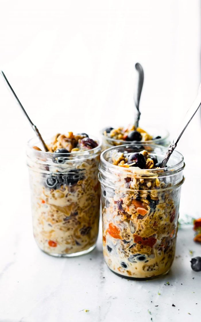 granola and yoghurt, with blueberries, inside a mason jar, chia seeds, meal prep, silver spoons