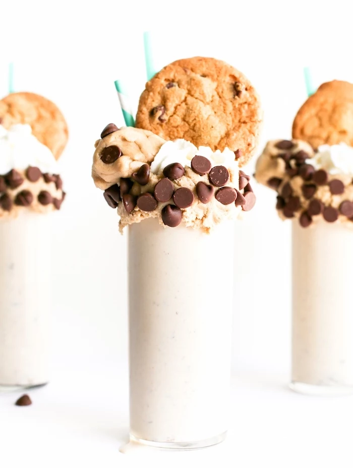 vanilla milkshake, cookie dough on top, cookies on top, tasty chocolate chip cookie, paper straws