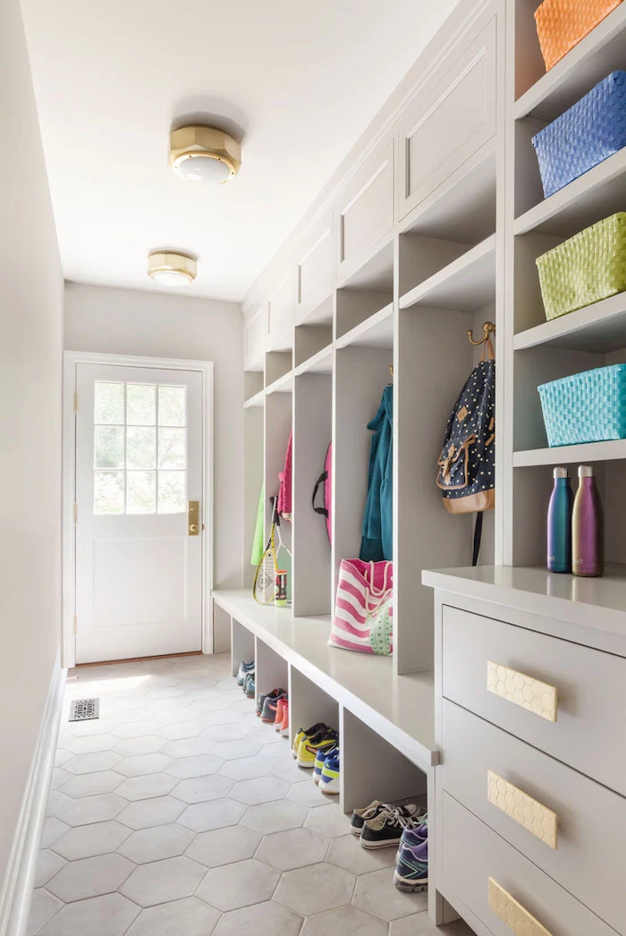 white wooden shelves and drawers, hanging jackets and backpacks, pairs of shoes, update your entrance hall
