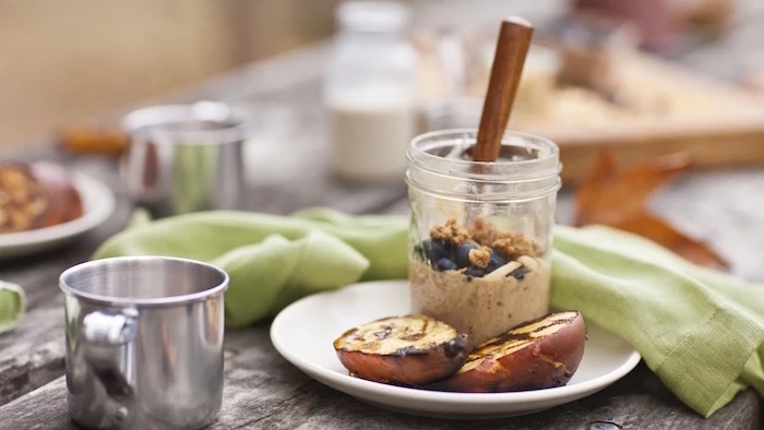 baked pears, granola and yoghurt, healthy meal prep ideas for the week, in mason jars, white plate