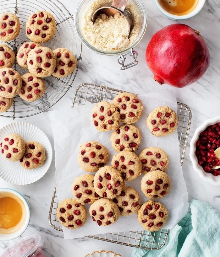 cookies with pomegranate seeds, chocolate chunk cookies, arranged on metal rail, white baking paper