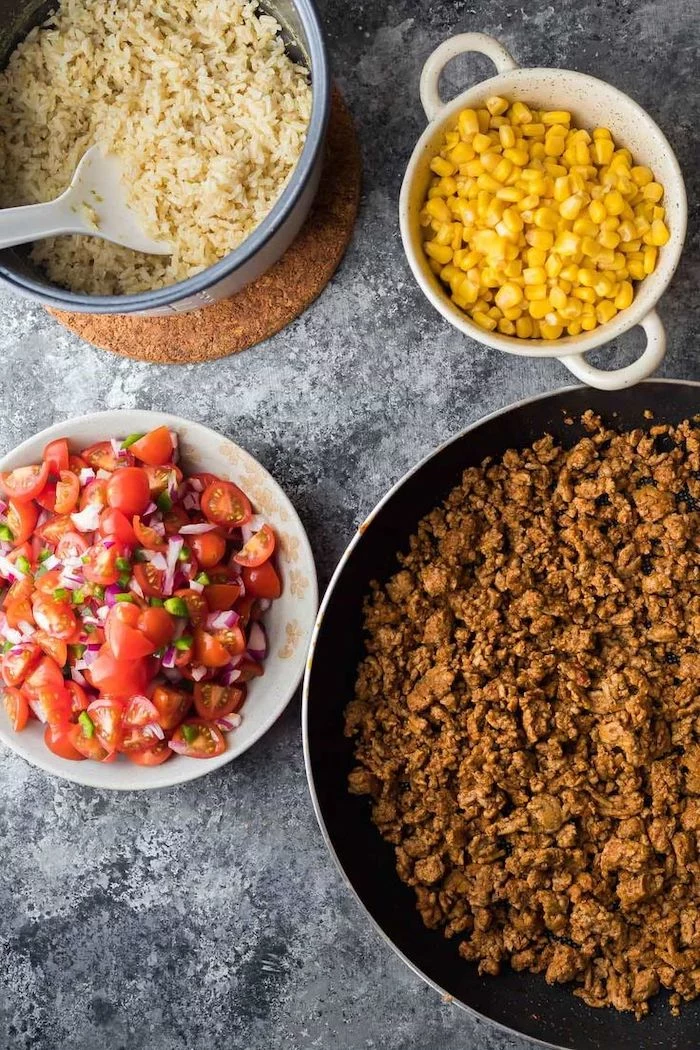 corn and salsa, in white bowls, ground turkey in a pan, boiled rice, chicken meal prep, granite countertop