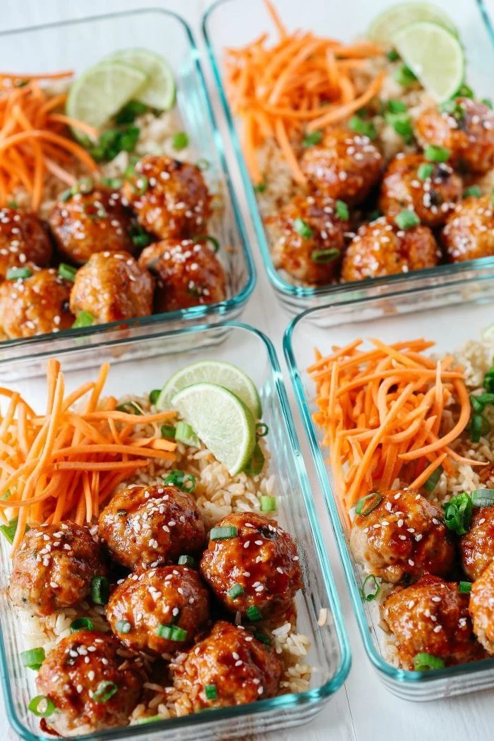 four glass containers, rice and carrots, honey sriracha meatballs, lime slices inside, healthy lunch recipes