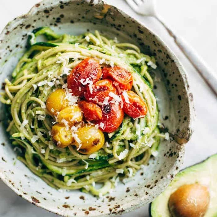 baked cherry tomatoes, parmesan on top, how to spiralize zucchini, ceramic bowl, avocado on the side