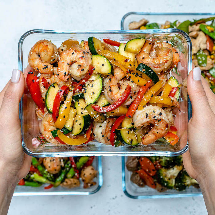 shrimp stir fry, inside a glass container, with sesame seeds, meal prep recipes chicken